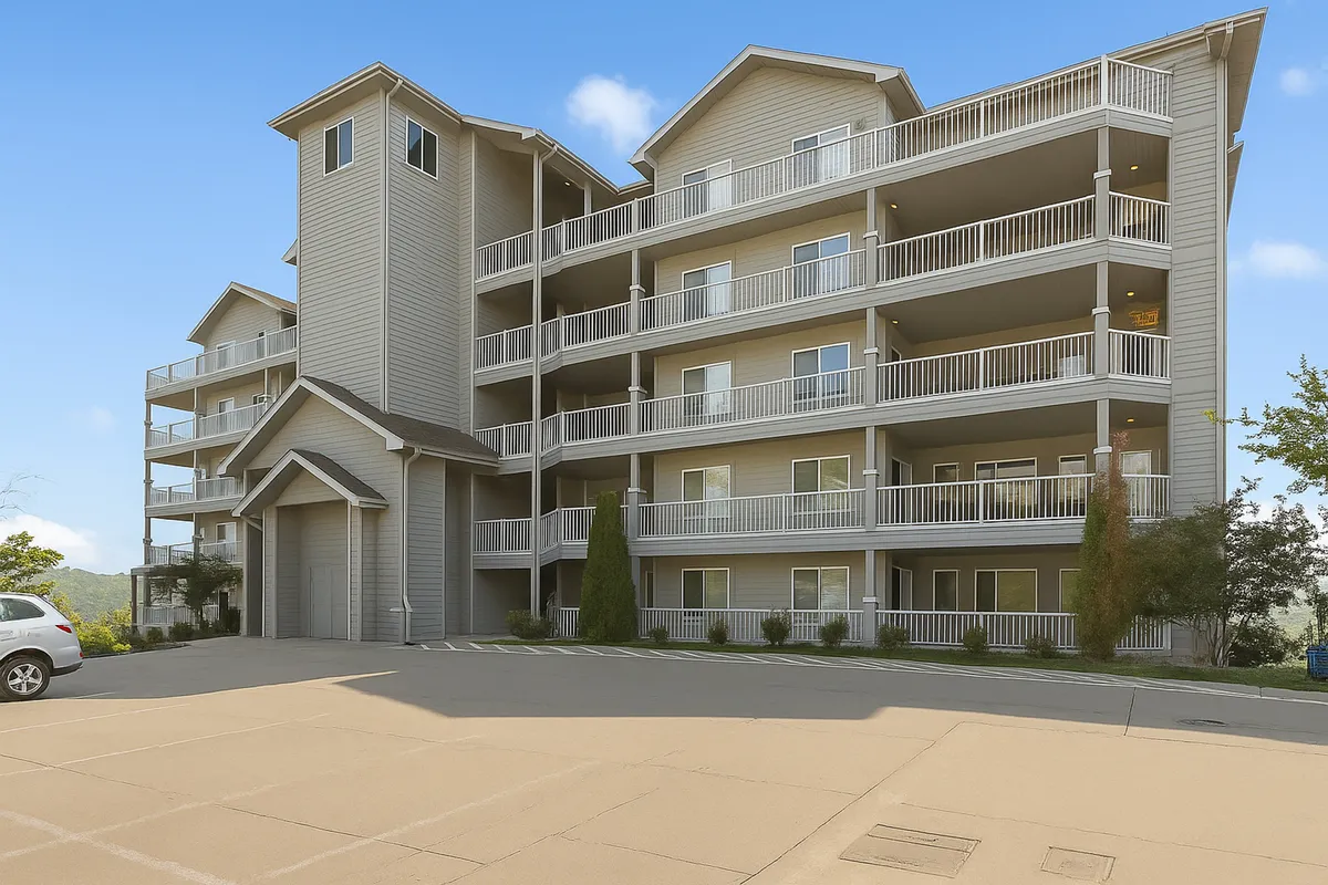 An exterior view of a multi-level building with balconies overlooking a landscaped area. The scene hints at serene mornings and relaxing evenings spent outside, with the natural surroundings and distant hills visible. The outdoor spaces suggest a connection to nature and opportunities to enjoy scenic moments, such as sunsets.